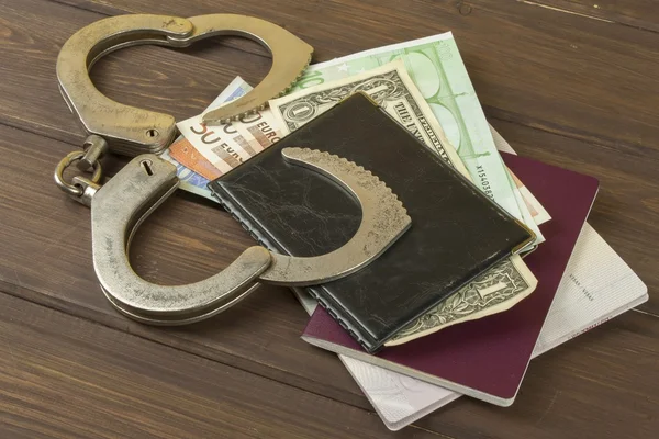 Traffickers international crime. Illegal crossing of the state border. Smuggling for money. Illegal immigrants. Paying smugglers for crossing the border. Real money and fake documents on the table. — Stock Photo, Image