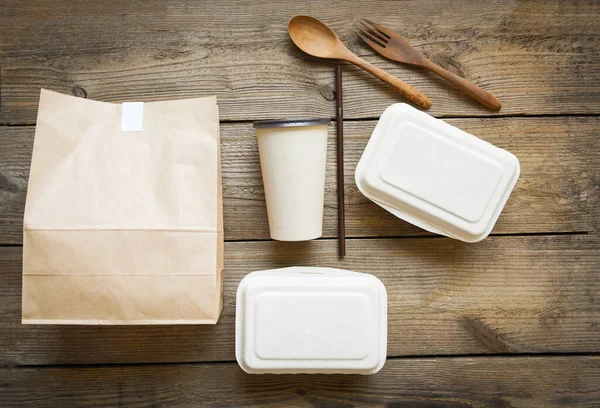Service food order online delivery food box take away boxes, Disposable eco friendly packaging containers with paper cup and craft paper food on wooden table at home