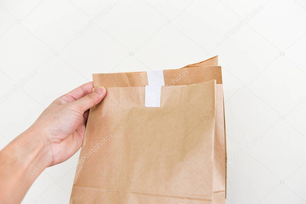 Disposable eco friendly packaging with craft paper shopping bag food in hand to home, Service food order online delivery food box take away boxes