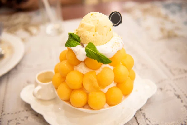 Bingsu dessert, fruit bingsu cantaloupe with milk cream menu eat cooling sweet iced served on the table Korea food