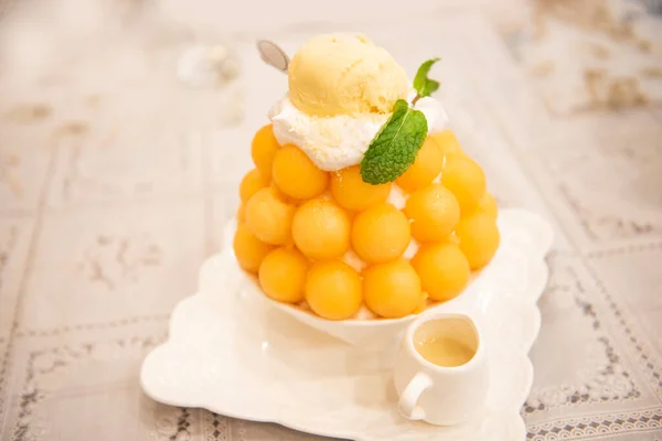 Bingsu dessert, fruit bingsu cantaloupe with milk cream menu eat cooling sweet iced served on the table Korea food