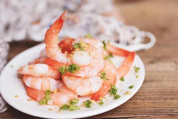 Garlic shrimp peeled on white plate background dining table food, Fresh shrimps prawns seafood lemon with herbs and spice