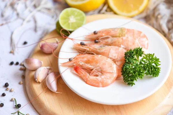 Garlic shrimp on white plate background on the table food kitchen, Fresh shrimps prawns seafood lemon lime with herbs and spice