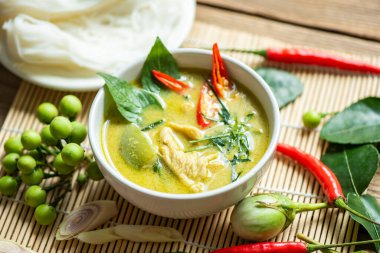 Traditional green curry chicken cuisine asian food, Chicken green curry Thai food on soup bowl with ingredient vegetable herbs and spices pepper chili. Top view