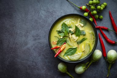Traditional green curry chicken cuisine asian food, Chicken green curry Thai food on soup bowl with ingredient vegetable herbs and spices pepper chili. Top view