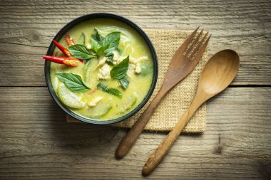 Traditional green curry chicken cuisine asian food, Chicken green curry Thai food on soup bowl with ingredient vegetable herbs and spices pepper chili. Top view