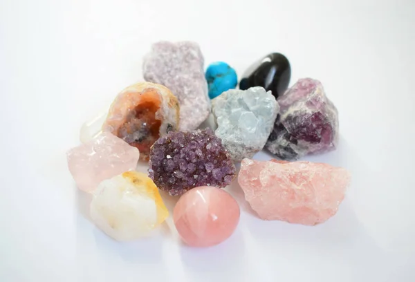 Gems lying on the table. Amethyst, rose quartz, turquoise, citrine, fluorite and other minerals