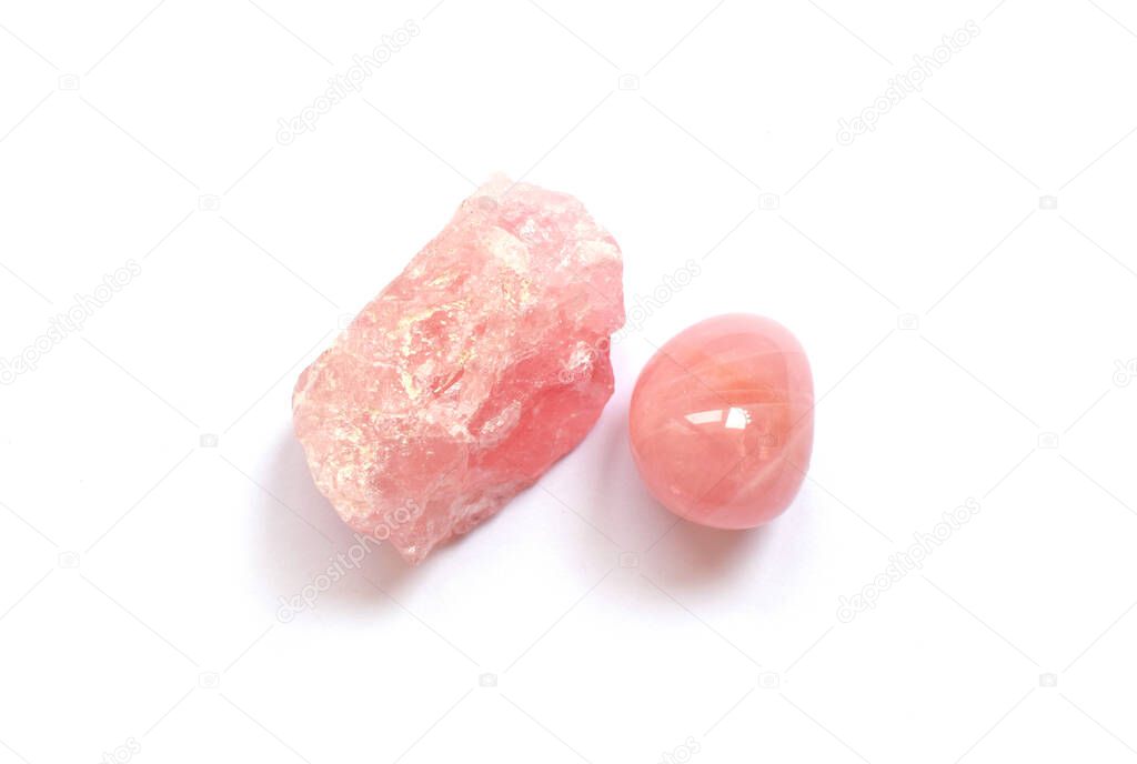 Gems lying on the table. Crystals of rose quartz, pink gemstone.