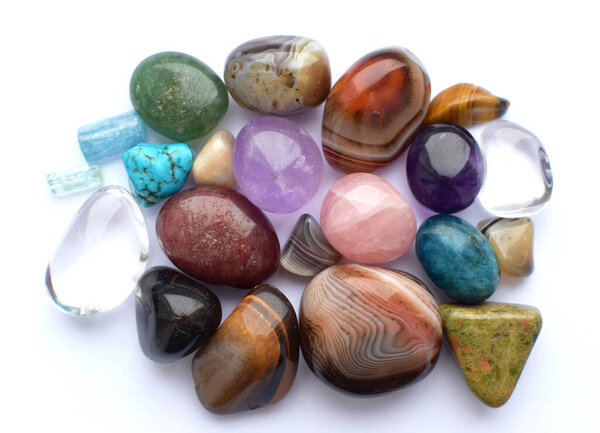 Tumbled gems of various colors. Amethyst, rose quartz, agate, apatite, aventurine, olivine, turquoise, aquamarine, rock crystal.
