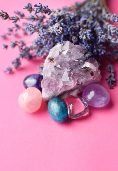 Beautiful amethyst crystals and round rose quartz stone with dry lavender bouquet. Magic amulets.