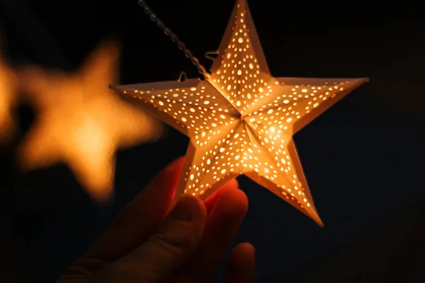 decorations for the holiday. white paper stars.background for Christmas and new year holidays. Paper Christmas stars are suspended on the background