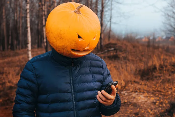 Scary Halloween Man Pumpkin Head Holds Mobile Phone His Hands — Stock Photo, Image