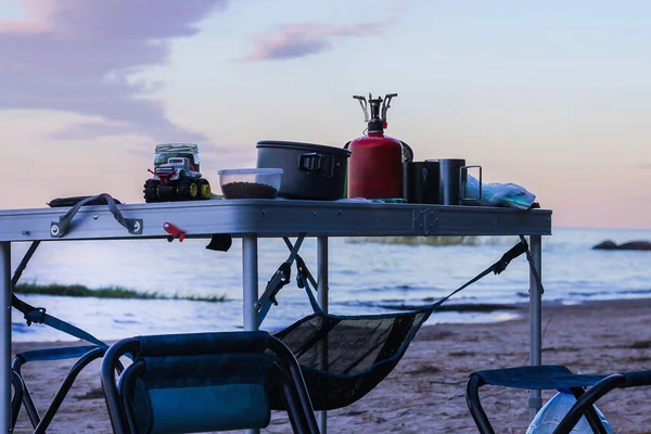 Picknick am See bei Sonnenuntergang. Kochen auf einem Feuer im Wald — Stockfoto