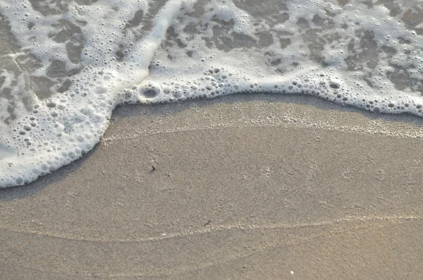 Closeup of sand and small wave — Stock Photo, Image
