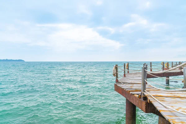 stock image Rock and wood bridge by the sea