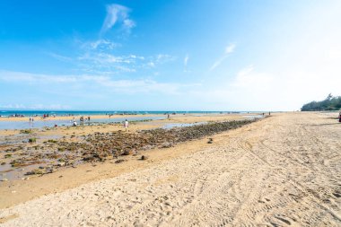 Mavi gökyüzünün altındaki kumsal