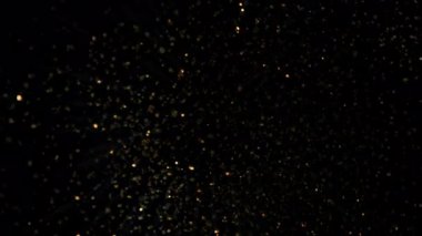 Siyah 1000fps 'te izole edilmiş, Altın Parıltılara doğru dönen Süper Yavaş Film Çekimi. Yüksek Hız Sinema Kamerası, 4K.