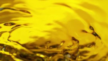 Dalgalanan Altın Sıvı Arkaplanının Süper Yavaş Çekimi, 1000fps. Yüksek Hız Sinema Kamerası, 4K.