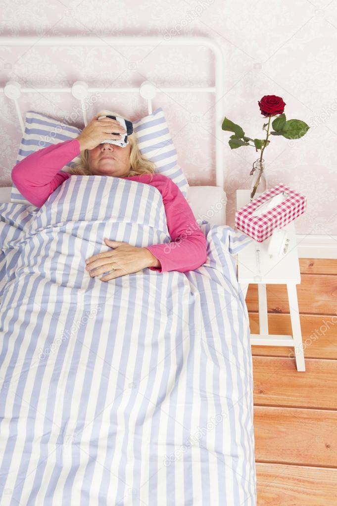 Woman lying in bed with headache