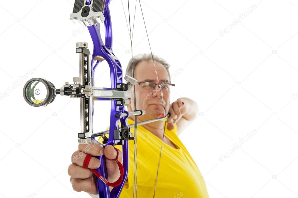 Man shooting with bow an arrow in close up