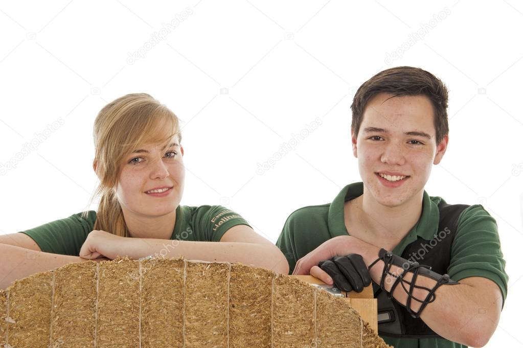 Girl and boy behind archery target