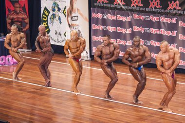 Bodybuilders showing their best chest pose in a lineup compariso