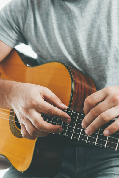Close-up on the hands of a guitarist playing classical guitar in two handed technique.
