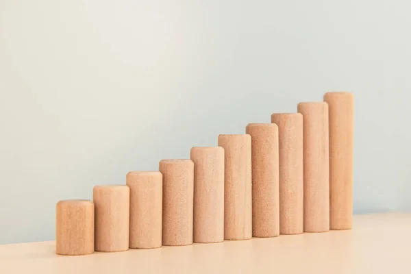 Growth bar chart, graph diagram made with wooden block on gray background and copy space. — Stock Photo, Image