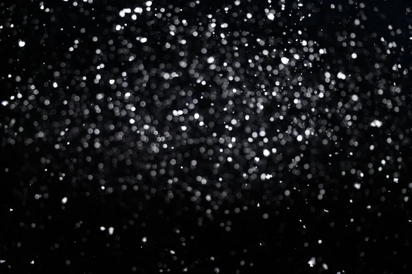 Out of focus snowfall for use as a texture layer in your project. Design element for overlay for your winter design.