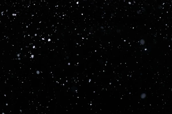 Real falling snow on black background for blending modes in ps. Ver 07 - few snowflakes in blur — Fotografia de Stock