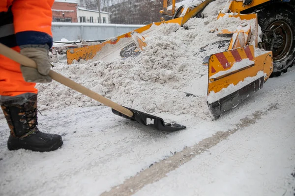 Snow plow and snow truck cleaning the streets during a snow storm in night maintenance action in Belgrade, Serbia