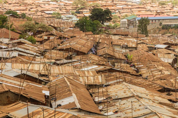 The brown and rusted roof tops of many buildings in the Kibera slum of Nairobi, Kenya.