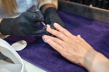 Manikür aracı kullanan profesyonel bir manikür sürecinin fotoğrafı