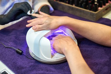 Manikür aracı kullanan profesyonel bir manikür sürecinin fotoğrafı