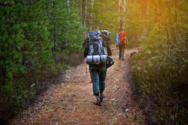 Sırt çantaları Günbatımı ile arkadan yürüme arkadaş grubu.