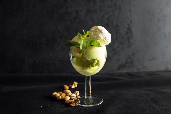 Pistachio and vanilla ice cream with mint on black background — Stock Photo, Image