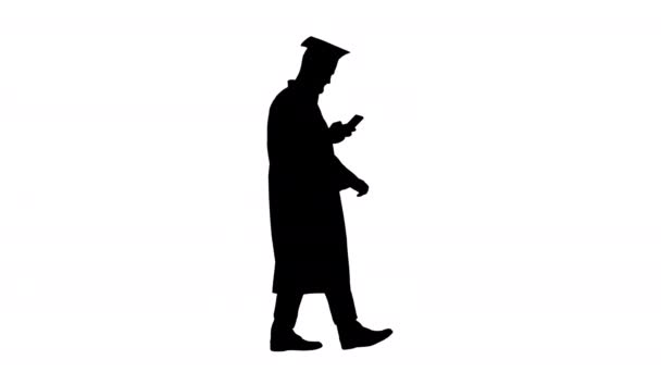 Graduate student walking and texting message on the phone, Alpha Channel — Vídeo de Stock