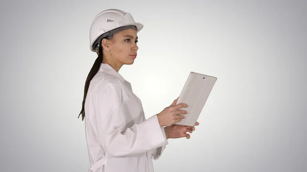 Young woman engineer walking with tablet looking at objects arou — Stock Photo, Image