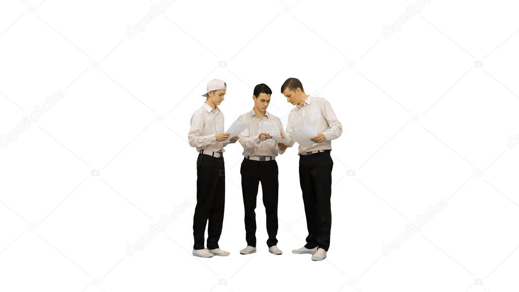 Three similar dressed guys reading some documents while one of t