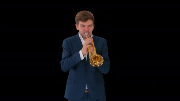 Young man in suit playing a trumpet while walking, Alpha Channel — Stock Video