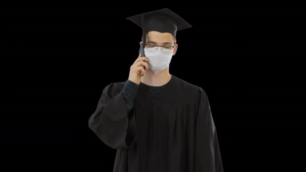 젊은 대학원생이 의료용 마스크를 쓰고 스마트폰으로 전화를 하고 있습니다. 알파 채널 — 비디오