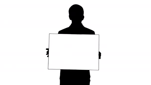 Silhouette Young businessman holding blank sign looking at camera. — Stock Video