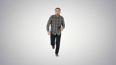 Erkek, gradyan arkaplanda günlük kıyafetlerle koşmaya başlar.