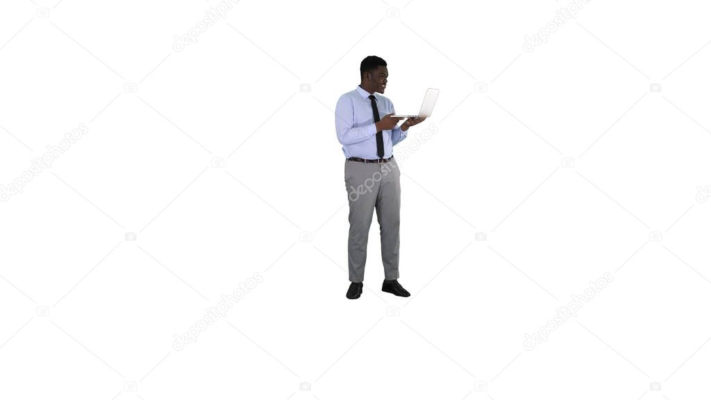 Cheerful successful young African American manager with laptop h