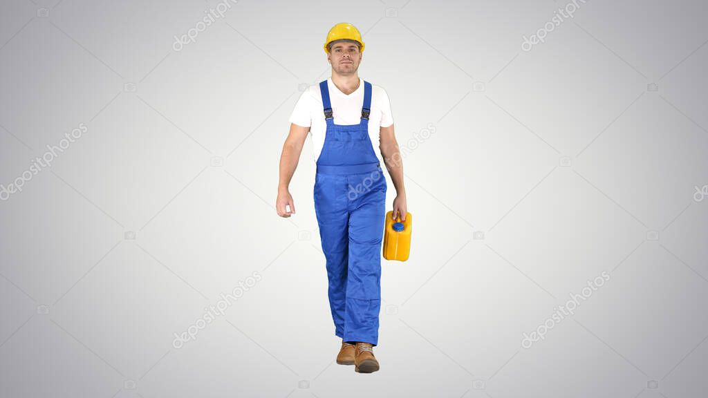 Construction worker in hard hat holding plastic canister and wal
