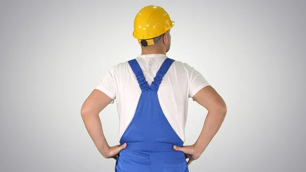 Inżynier w kasku budowlanym stoi z rękami na biodrach wygląd — Zdjęcie stockowe
