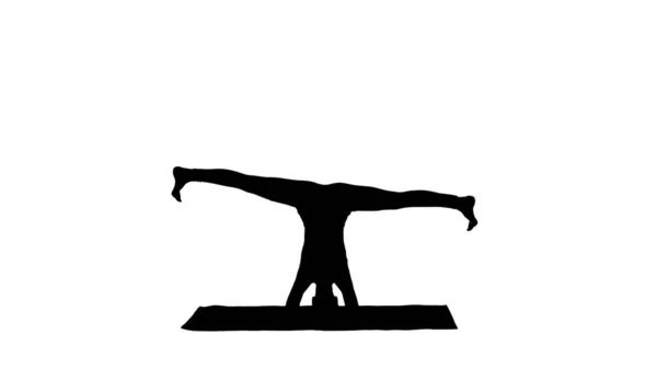 Silhouette Woman performing a headstand with split. — Stock Photo, Image