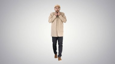 Genç yakışıklı adam yürür ve düğmelerini ilikler.