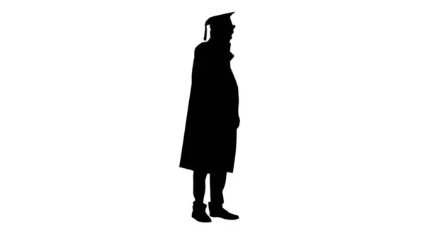 Silhouette Male graduate in gown and mortarboard having conversa — Stock Photo, Image