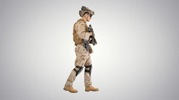 Armed Marine Soldier with rifle walking on gradient background.